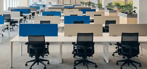 Modern open-plan office space featuring clean workstations, ergonomic chairs, and sanitized carpets provided by professional office cleaning services in Overland Park, KS.