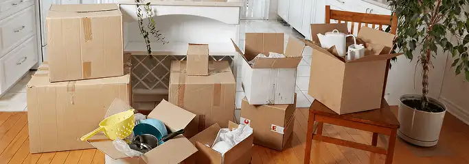 Packed moving boxes and household items in a kitchen before move-out or move-in cleaning, Overland Park, KS.